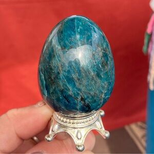 Blue apatite polished crystal egg on stand
